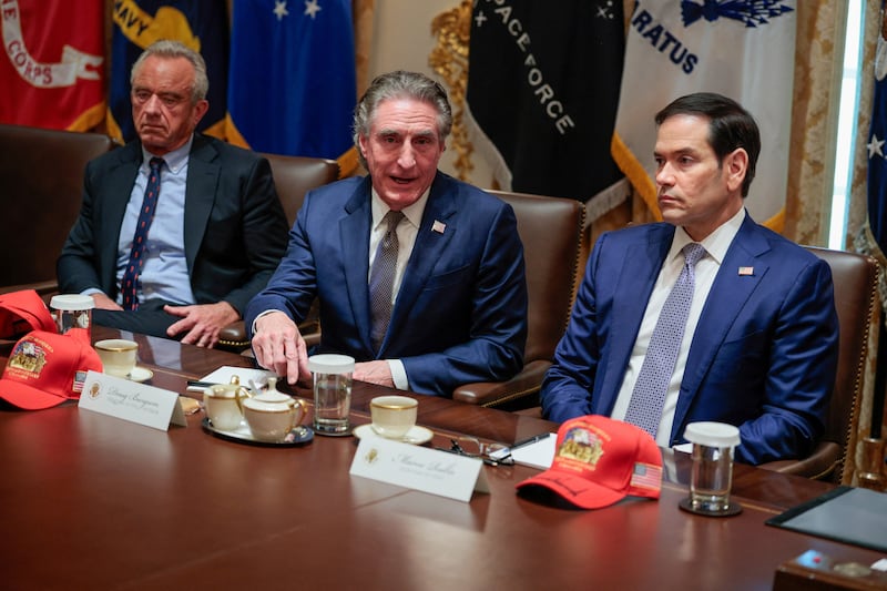 Interior Secretary Doug Burgum speaks next to Secretary of State Marco Rubio who looks thrilled with his signed Trump cap.