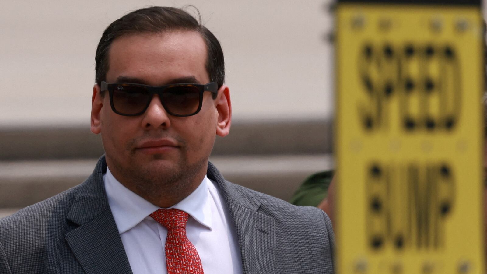 U.S. Representative George Santos looks on outside the Central Islip Federal Courthouse on the day of his hearing