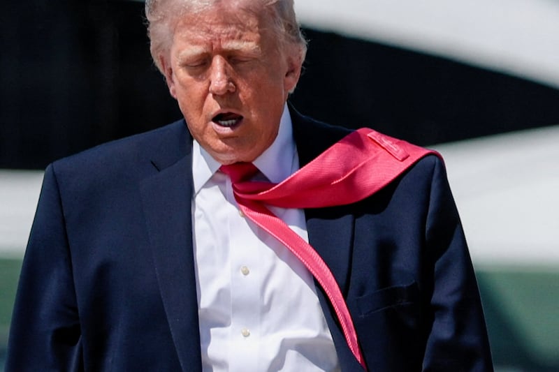 U.S. President Donald Trump's tie is blown by the wind as he walks to board Air Force One for his trip to Las Vegas, Nevada, as he departs Joint Base Andrews, Maryland, U.S., on the day he announced that Israeli and Lebanese leaders had agreed to begin a 10-day ceasefire, April 16, 2026. REUTERS/Evan Vucci