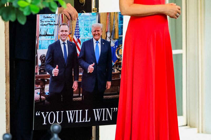 A poster with images of President of Poland Karol Nawrocki and U.S. President Donald Trump is carried, following the presidents' meeting at the White House in Washington, D.C., U.S., September 3, 2025.  REUTERS/Brian Snyder     TPX IMAGES OF THE DAY