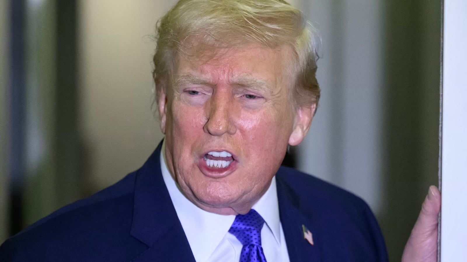 President Donald Trump speaks to reporters while in flight on Air Force One, en route Joint Base Andrews from West Palm Beach, Florida on February 16, 2026.