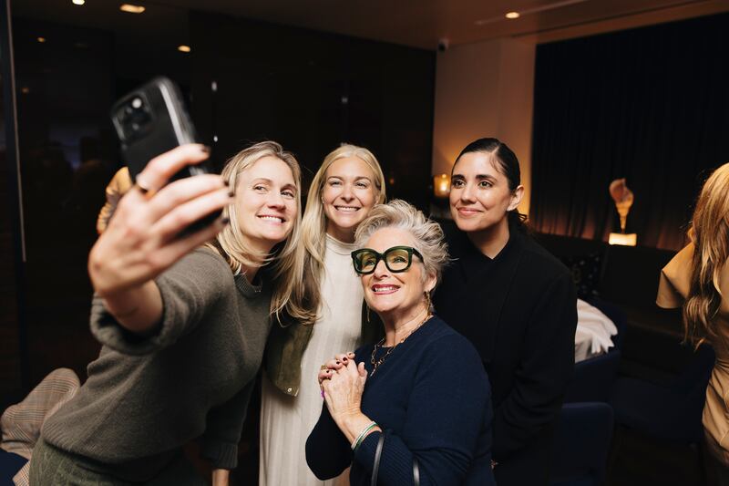 Guests snap a group selfie with Laurie Dowley (second from right).