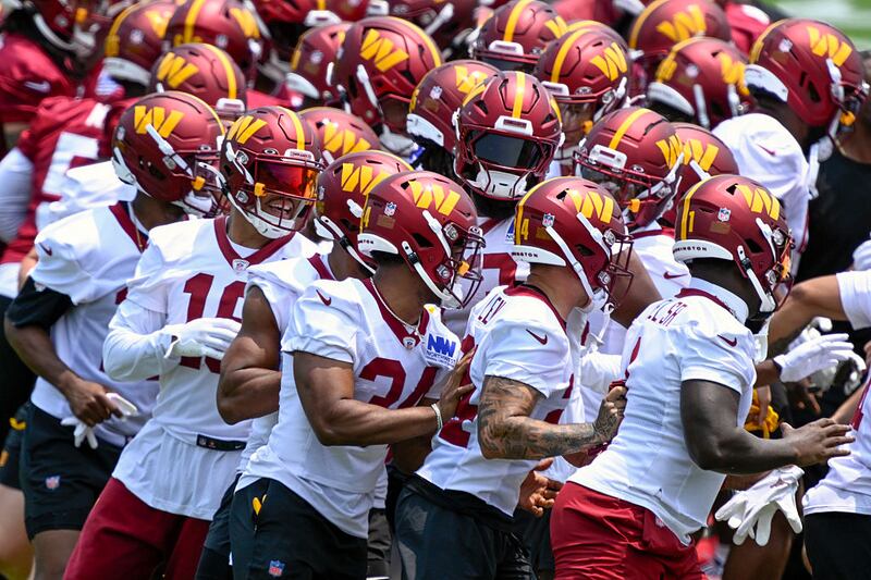 ASHBURN, VA - June 11: Washington Commanders players run through a gauntlet to start day two of mini camp in Ashburn, VA on June 11, 2025. (Photo by John McDonnell/For The Washington Post via Getty Images)