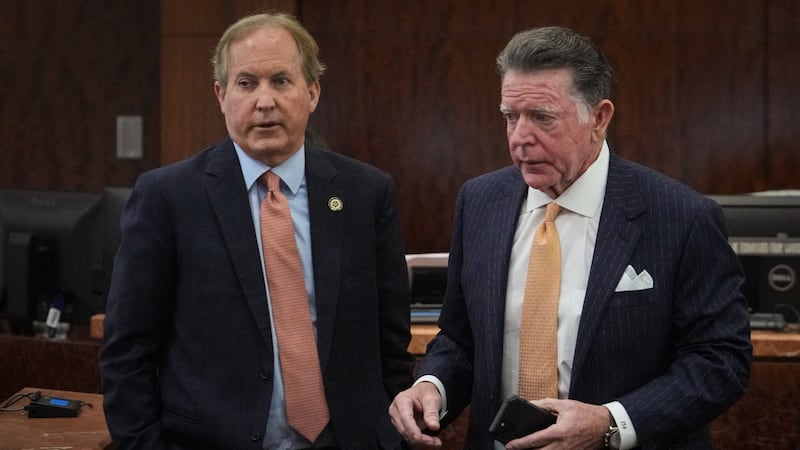 Texas Attorney General Ken Paxton, left, appears in the 185th District Court with Dan Cogdell, one of his defense attorneys, for a hearing in his securities fraud case Friday, Feb. 16, 2024, at the Harris County criminal courthouse in Houston.