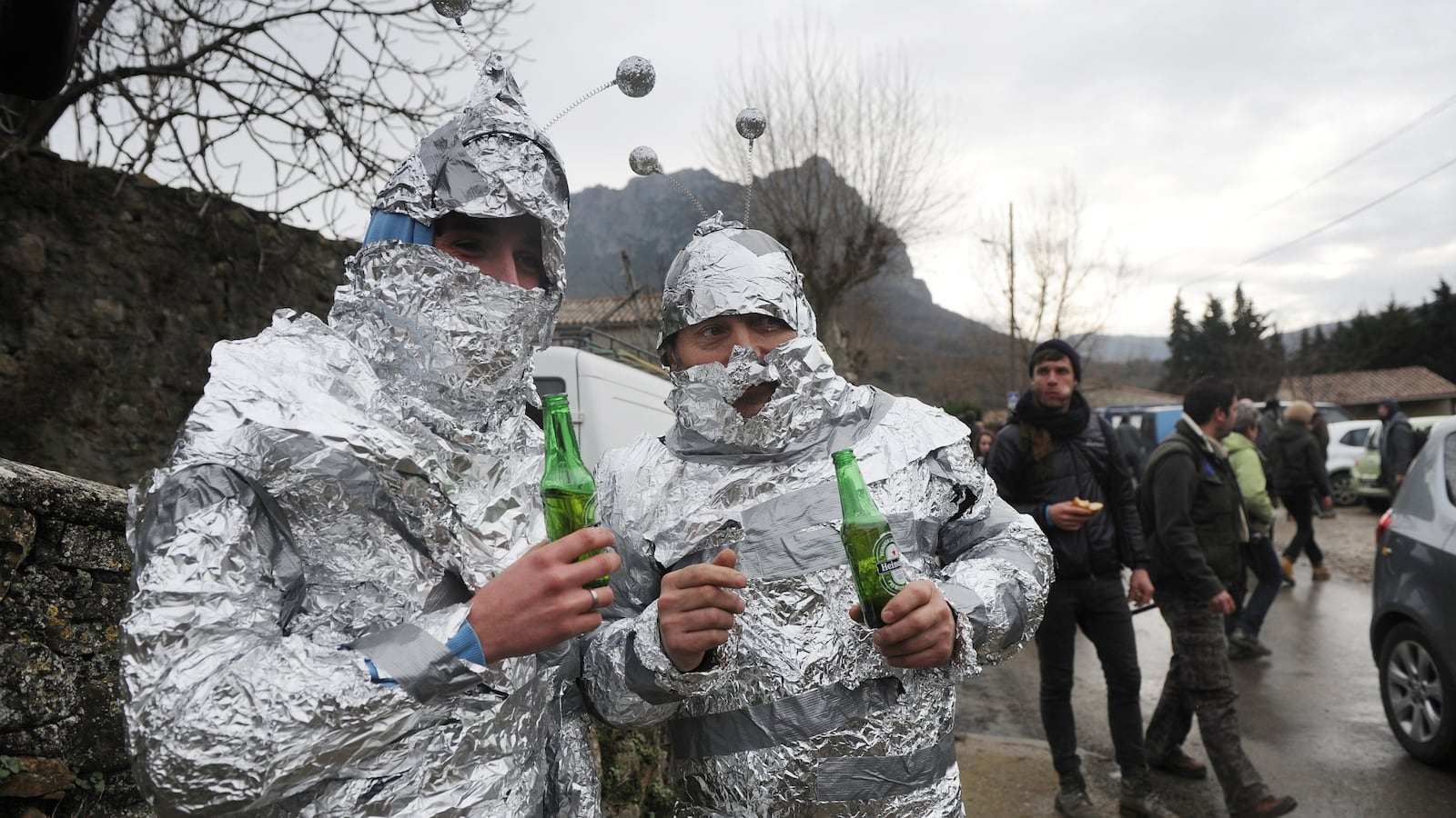 Men dressed as "martians" in tin foil drink beers in Bugarach, France, in 2012.