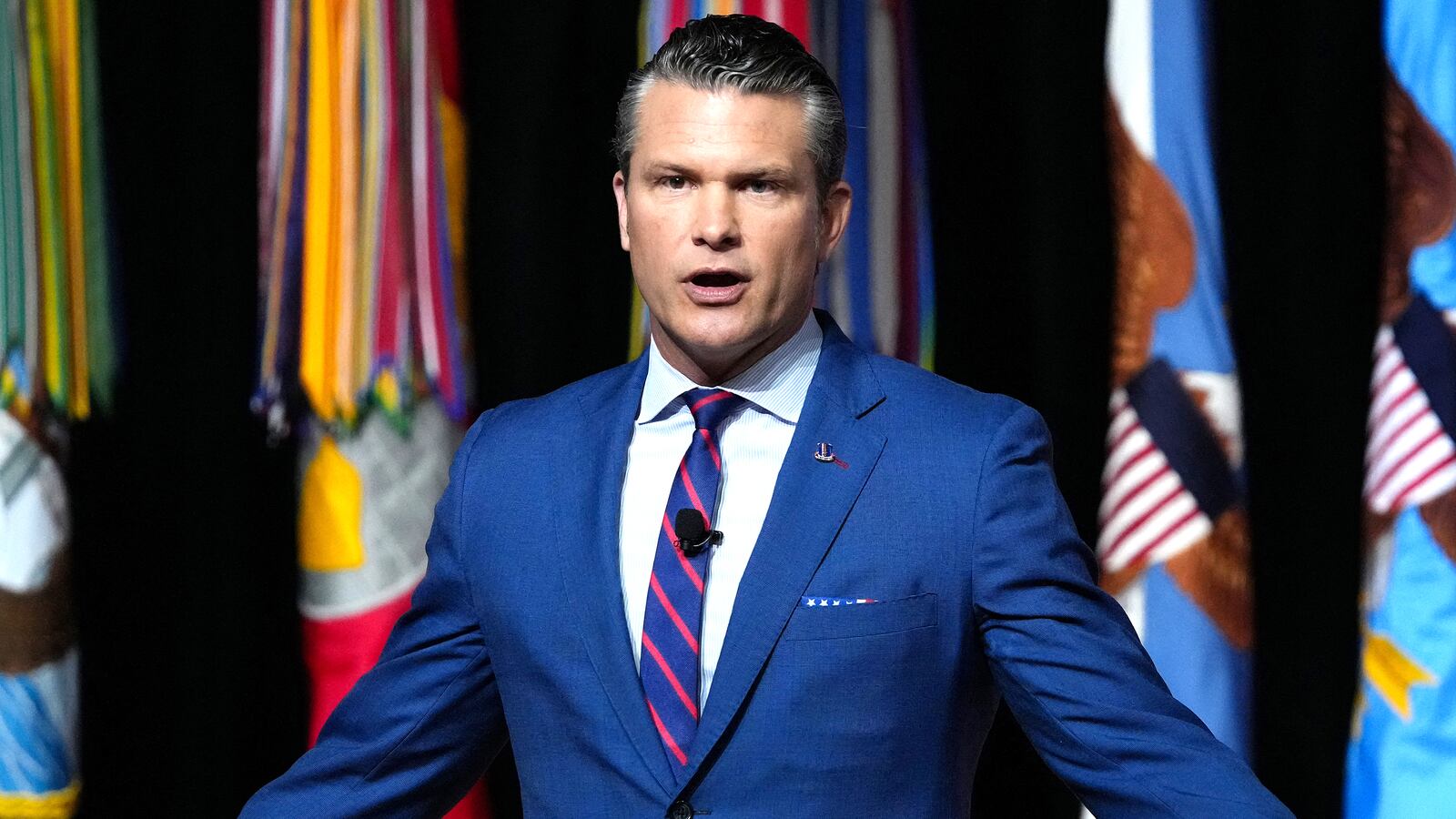 US Secretary of Defense Pete Hegseth addresses senior military officers at Marine Corps Base Quantico in Quantico, Virginia, on September 30, 2025. Pentagon chief Pete Hegseth on Tuesday told a rare gathering of top brass called back from bases around the world that the US military will be reformed to end what he called "decades of decay." Speaking to hundreds of generals and admirals in Quantico, Virginia, Hegseth declared an end to "ideological garbage," giving concerns over climate change, bullying, "toxic" leaders, and promotions based on race or gender as examples. (Photo by Andrew Harnik / POOL / AFP) (Photo by ANDREW HARNIK/POOL/AFP via Getty Images)