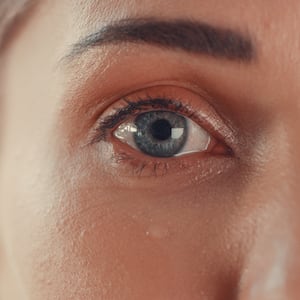 Portrait of a young woman’s eyes as she cries