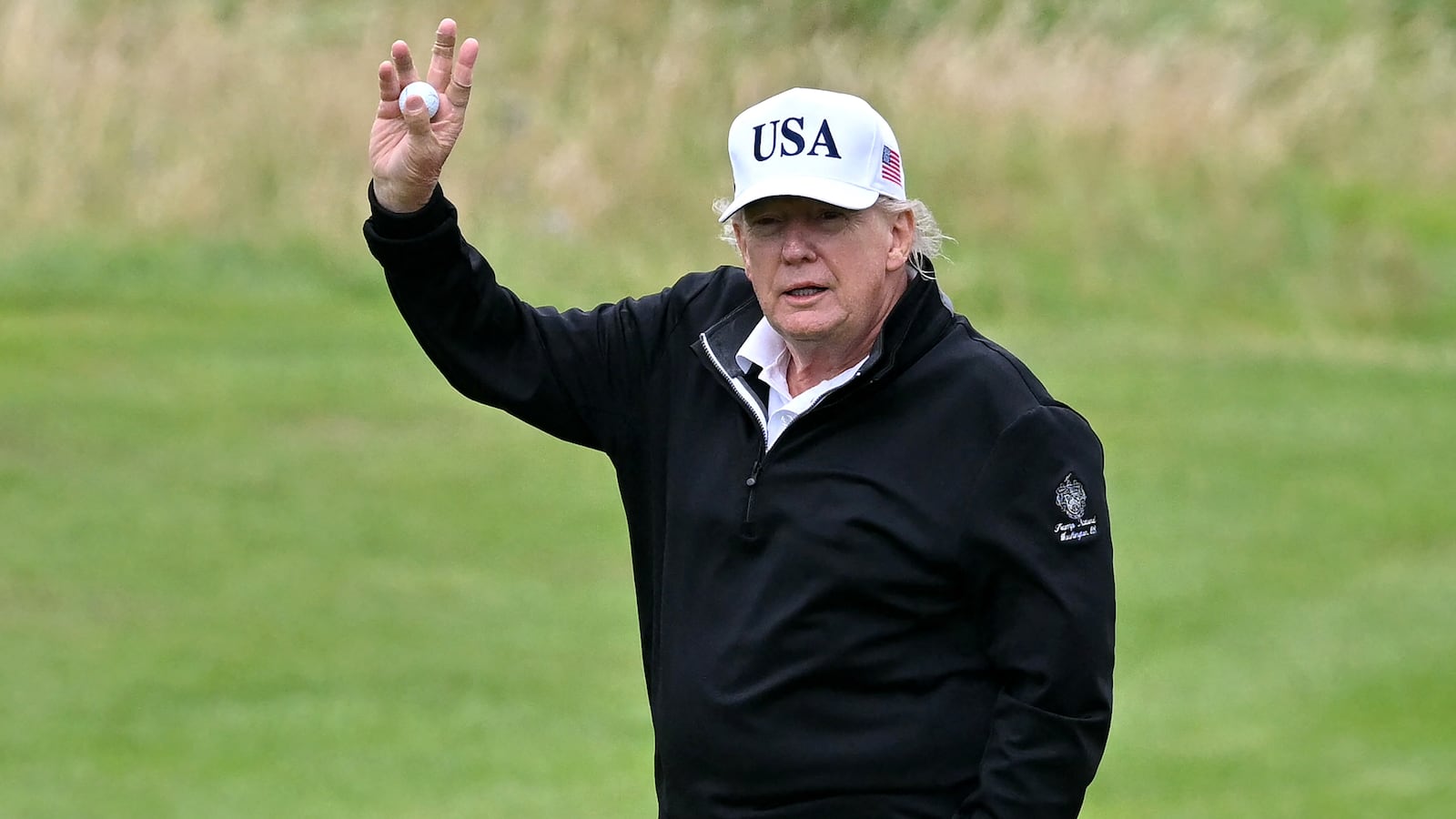 President Donald Trump reacts as he plays golf at the Trump Turnberry Golf Courses, in Turnberry on the south west coast of Scotland on July 27, 2025.