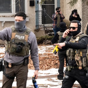 Observers film ICE agents as they hold a perimeter after one of their vehicles got a flat tire on Penn Avenue on February 5, 2026 in Minneapolis, Minnesota. Protests continue calling for an end to immigration raids in the Twin cities which have already resulted in the fatal shooting deaths of Alex Pretti, a VA nurse, and Renee Good, a mother of three, by federal agents.