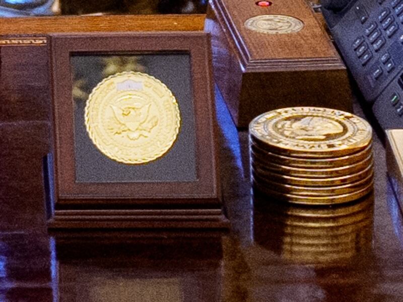 Donald Trump in the Oval Office behind his desk with microphones visible and Zohran Mamdani to the left