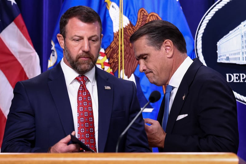 US Attorney General Todd Blanche steps off as Homeland Security Secretary Markwayne Mullin steps up to speak during a press conference at the Department of Justice in Washington, D.C., US, September 30, 2026. REUTERS/Kevin Lamarque
