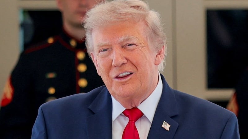 U.S. President Donald Trump reacts after being given a personalised racing helmet during a Freedom 250 Grand Prix Showcase at the White House in Washington, D.C., U.S., July 13, 2026.