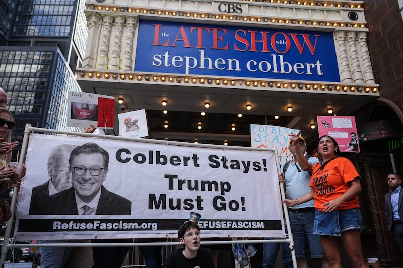 Dozens of anti-Trump protesters gathered outside the Ed Sullivan Theater, home of The Late Show with Stephen Colbert, to protest CBS's reported decision to fire the longtime host. Demonstrators held signs and chanted in support of Colbert, blaming political pressure and criticizing the network's move as a blow to free speech and satire. The protest came shortly after rumors surfaced that Colbert's termination was linked to his outspoken criticism of President Donald Trump.
