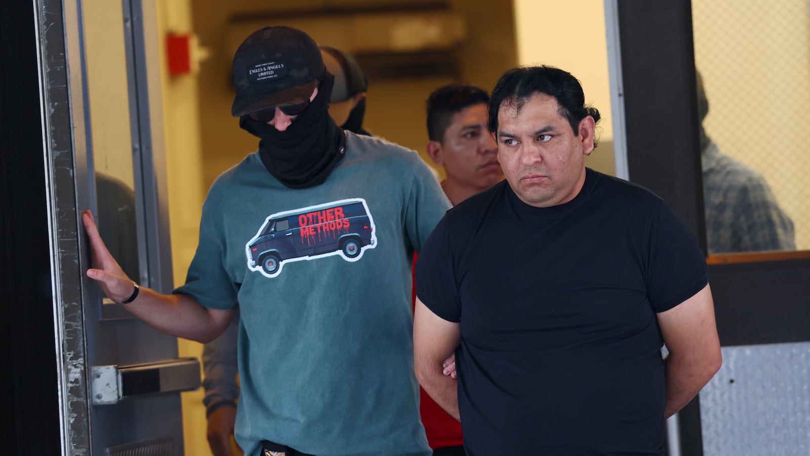 NEW YORK, NEW YORK - JUNE 04: Federal agents escort detainees to vehicles after exiting an Intensive Supervision Appearance Program office on June 04, 2025 in New York City. Federal agents are arresting immigrants during mandatory check-ins, as ICE ramps up enforcement following immigration court hearings. The Trump administration has ordered officials to increase detentions to 3,000 migrants per day. (Photo by Michael M. Santiago/Getty Images)