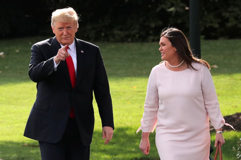 U.S. President Donald Trump talks with White House Press Secretary Sarah Huckabee Sanders while departing the White House for travel to a campaign rally in Iowa in Washington, U.S. October 9, 2018.  REUTERS/Jonathan Ernst