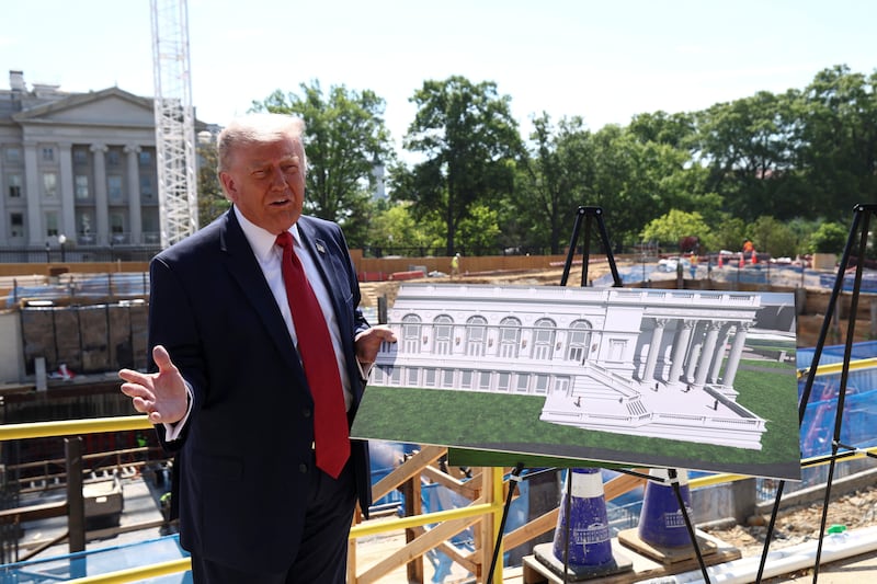 President Donald Trump shows images of the concept at the site of the ongoing construction of the planned White House ballroom in Washington, D.C., on May 19, 2026.
