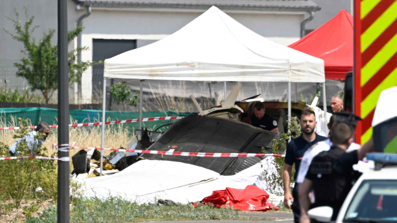 Security personnel look at the wreckage of a Pilatus PC-6 light aircraft after it crashed at Tomblaine, on the outskirts of Nancy, eastern France on June 28, 2026. (Photo by Jean-Christophe VERHAEGEN / AFP via Getty Images)