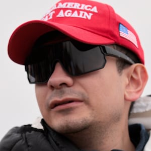 Bryan Betancur holds a Certificate of Pardon from President Donald Trump during a January 6th memorial march marking five years since the attack on January 06, 2026, in Washington, DC.