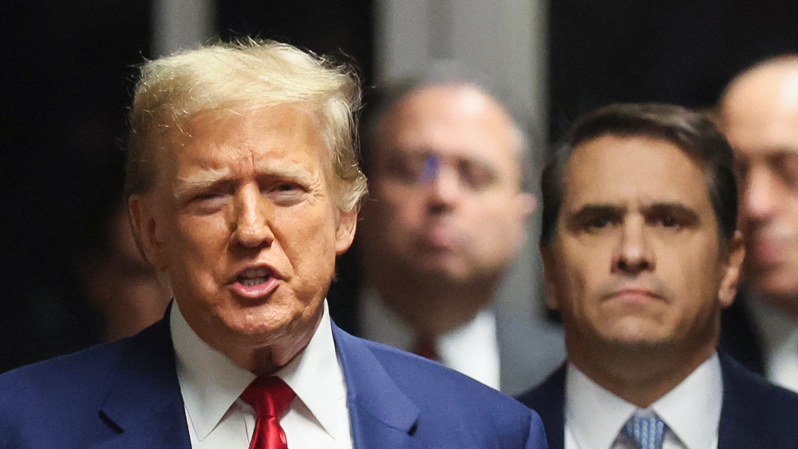 Former US President Donald Trump speaks to the press in a hallway outside the courtroom in a hearing to determine the date of his trial for allegedly covering up hush money payments, at Manhattan Criminal Court in New York City on March 25, 2024