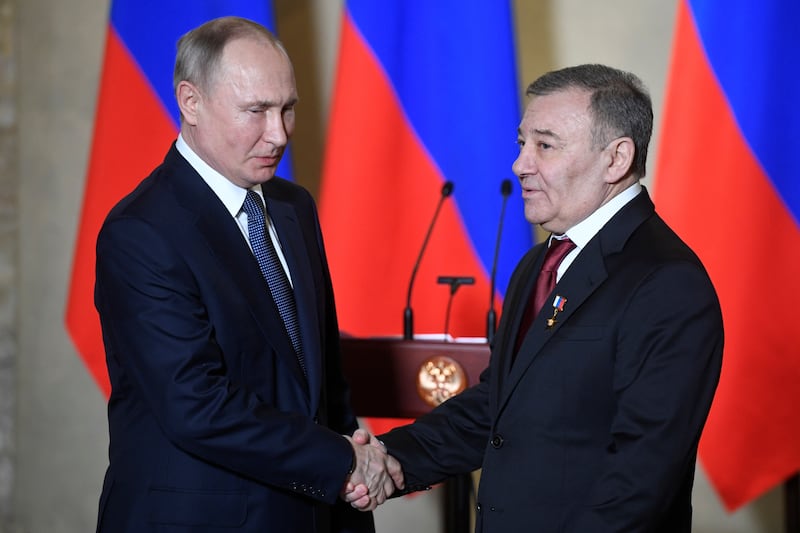 Russian President Vladimir Putin decorates businessman Arkady Rotenberg with the Hero of Labour medal during a ceremony to award constructors of the Crimean Bridge over the Kerch Strait in Sevastopol, Crimea March 18, 2020.