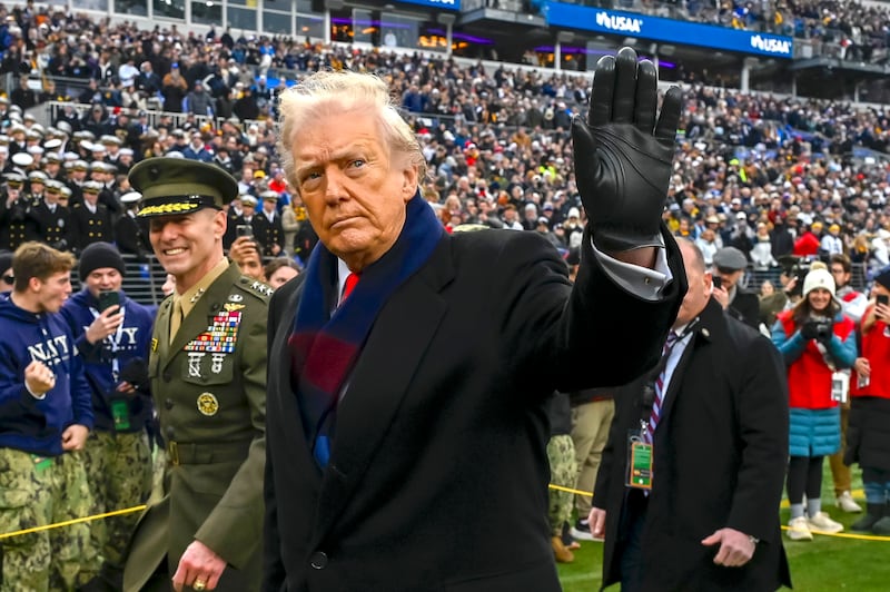 Donald Trump  waves while leaving the field before the game between the Navy Midshipmen and the Army West Point Black Knights  at M&T Bank Stadium.