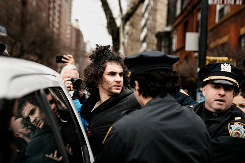 A man identified as Emir Balat is detained by police officers during a rally to stop public Muslim prayer outside the Gracie Mansion official residence of Mayor Zohran Mamdani in New York City, U.S., March 7, 2026. REUTERS/Eduardo Munoz