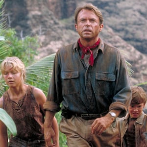 Actor Sam Neill as Dr. Alan Grant, with Ariana Richards (left) and Joseph Mazzello (right) as Lex and Tim, in a scene from the film 'Jurassic Park', 1993.