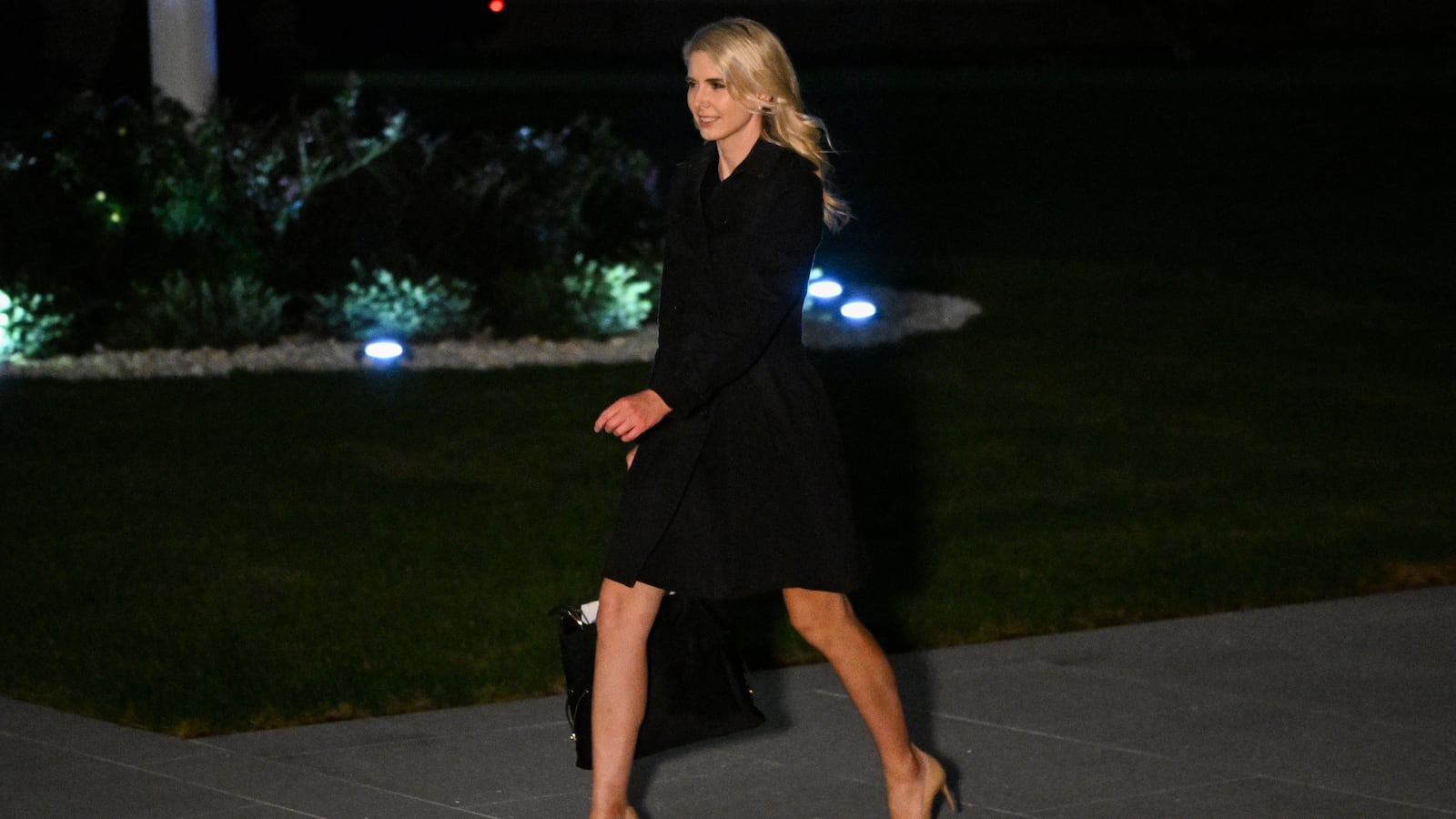 Executive assistant to US President Donald Trump, Natalie Harp, walks to the White House from Marine One on the South Lawn in Washington, DC, on October 3, 2026. President Trump is returning from Ohio where he spoke at a midterm campaign rally. (Photo by Alex WROBLEWSKI / AFP via Getty Images)