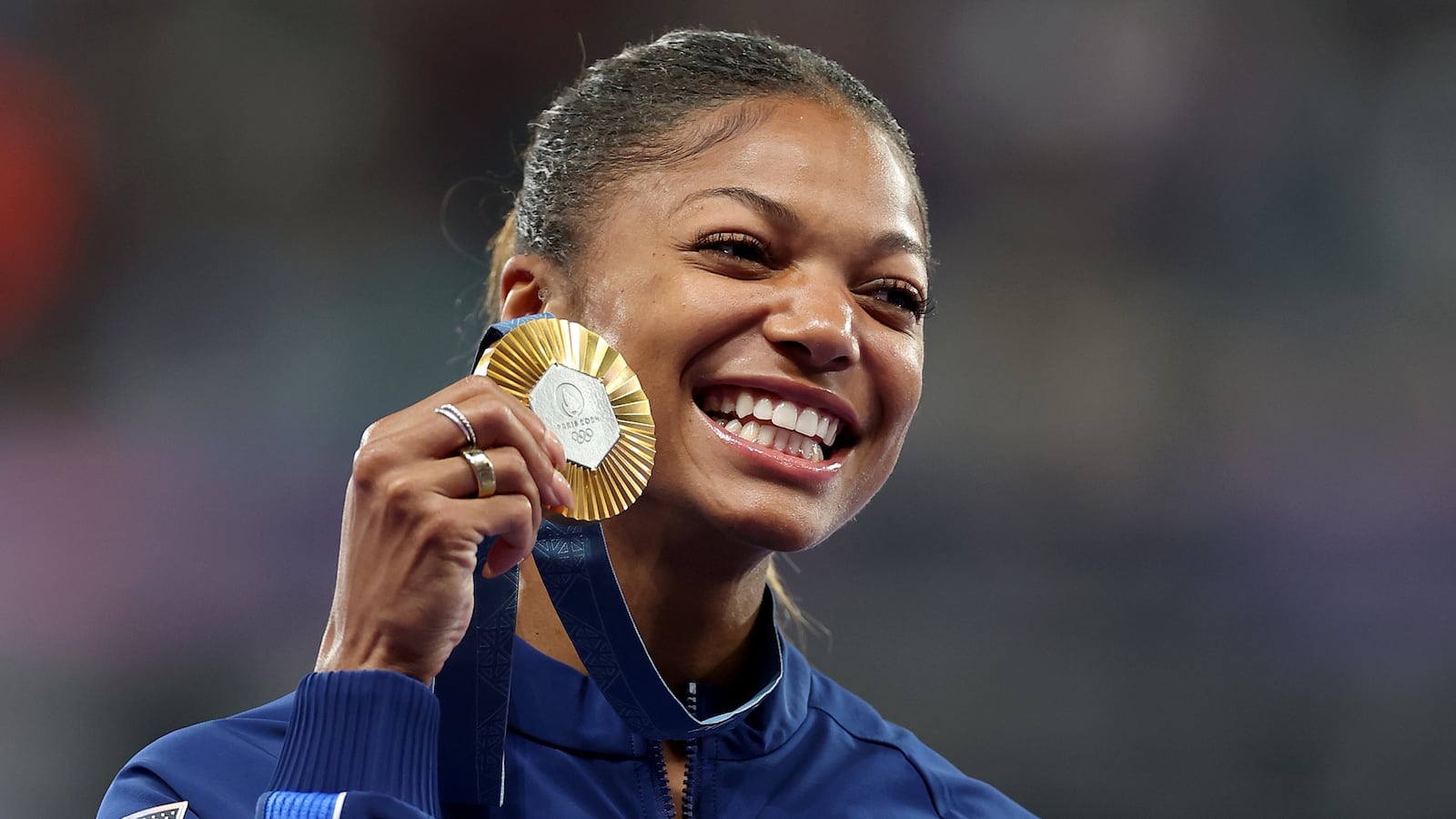 Gold medalist Gabrielle Thomas of Team United States celebrates on the podium during the Women's 200m medal ceremony on day twelve of the Olympic Games Paris 2024 at Stade de France on August 07, 2024 in Paris, France.