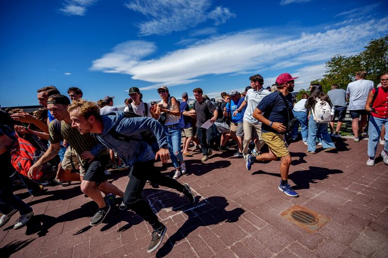 People run after a shot was fired at Charlie Kirk during a Utah Valley University speaking event in Orem, Utah.