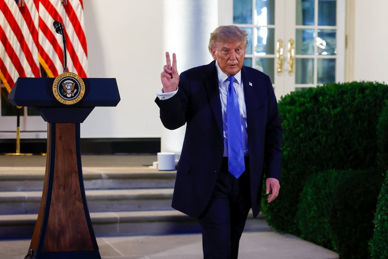 U.S. President Donald Trump leaves the podium after speaking at a dinner in the Rose Garden.
