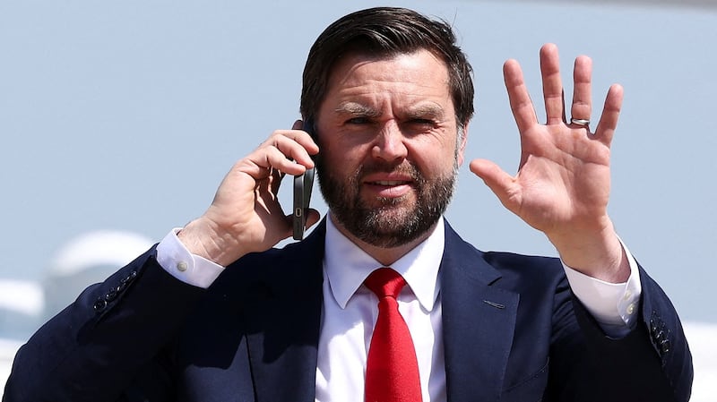 U.S. Vice President JD Vance talks on the phone on his way to  board  Air Force Two, as he departs for South Carolina to visit a steel factory, at Joint Base Andrews, Maryland, U.S., May 1, 2025.