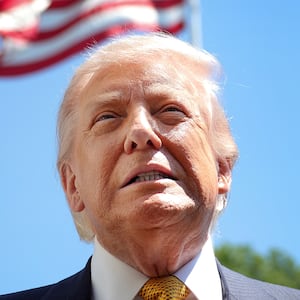 WASHINGTON, DC - MAY 12: U.S. President Donald Trump speaks in front of the American flag to the press as he departs the White House on May 12, 2026 in Washington, DC. Trump is traveling to China where he is scheduled to meet with Chinese President Xi Jinping for expected talks on the Iran conflict, trade imbalances, regional security, and economic cooperation between the two countries. (Photo by Kevin Dietsch/Getty Images)