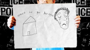 A child holding a drawing by Gerson López Garcia.