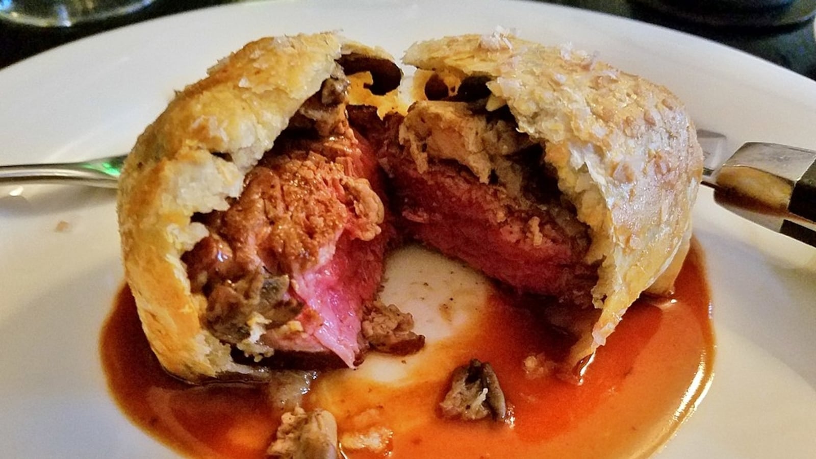 Beef wellington on a plate, with mushrooms