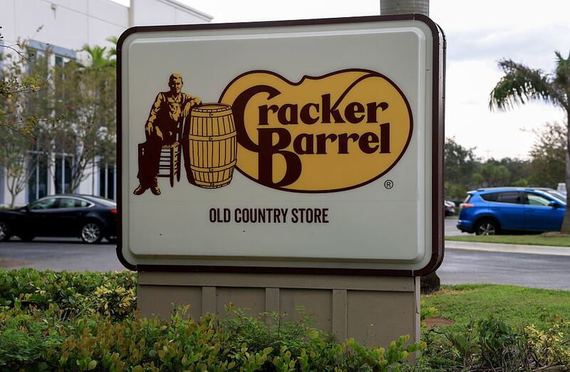 PEMBROKE PINES, FLORIDA - AUGUST 21: A Cracker Barrel sign featuring the old logo hangs on the outside of a restaurant on August 21, 2025 in Homestead, Florida. The restaurant unveiled a new logo earlier this week as part of a larger brand refresh. The new logo removes the image of a man sitting next to a barrel and the phrase “old country store”. Now the logo will feature the words “Cracker Barrel” against a yellow background. (Photo by Joe Raedle/Getty Images)