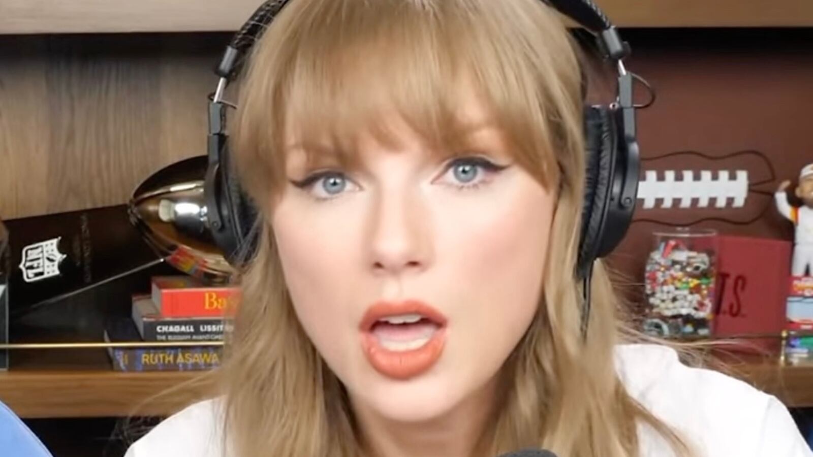 Taylor Swift with Travis Kelce on New Heights podcast.