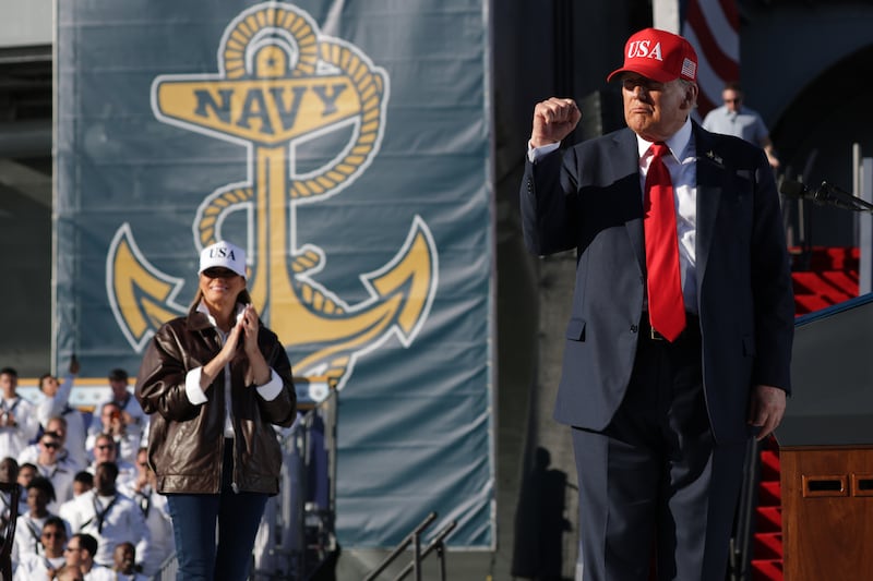 First Lady Melania Trump claps as U.S. President Donald Trump raises his fist after making remarks during the Navy 250 Celebration