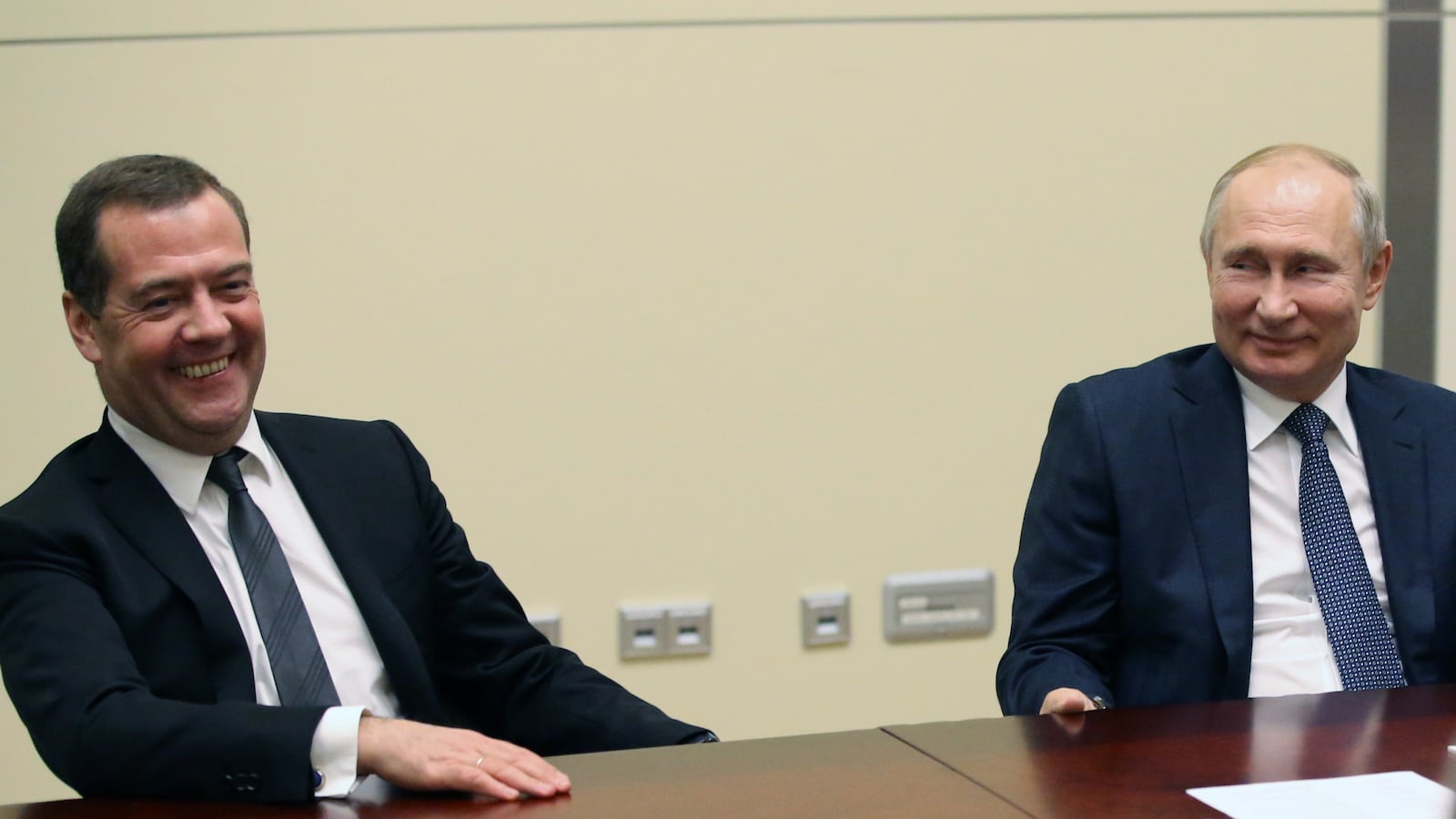 Russian President Vladimir Putin and then-Russian Prime Minister Dmitry Medvedev smile during talks in Sochi.
