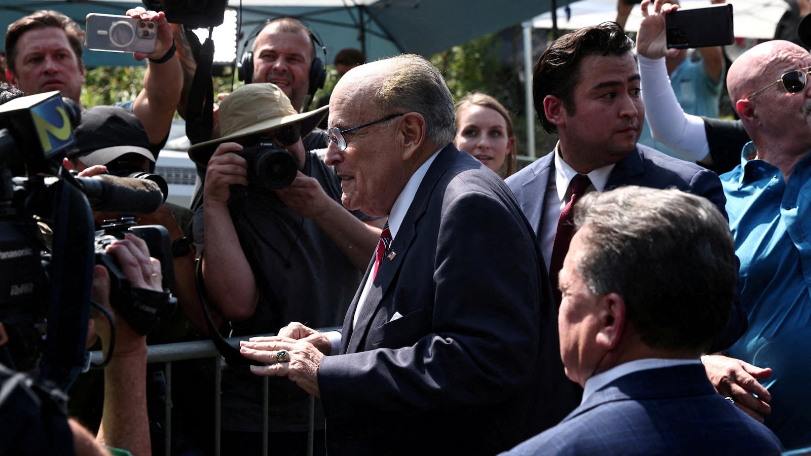 Former New York City Mayor Rudy Giuliani speaks to reporters outside the Fulton County Jail