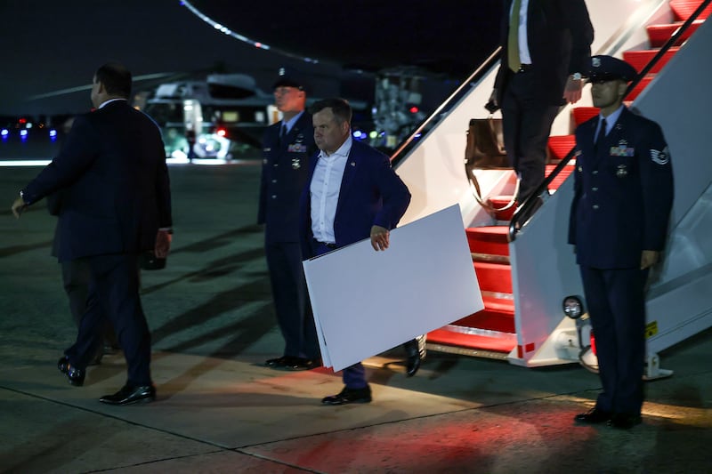 Bill Pulte, director of the U.S. Federal Housing Finance Agency, carries poster boards as he follows President Donald Trump off of Air Force One on September 16, 2026 in Joint Base Andrews, Maryland.