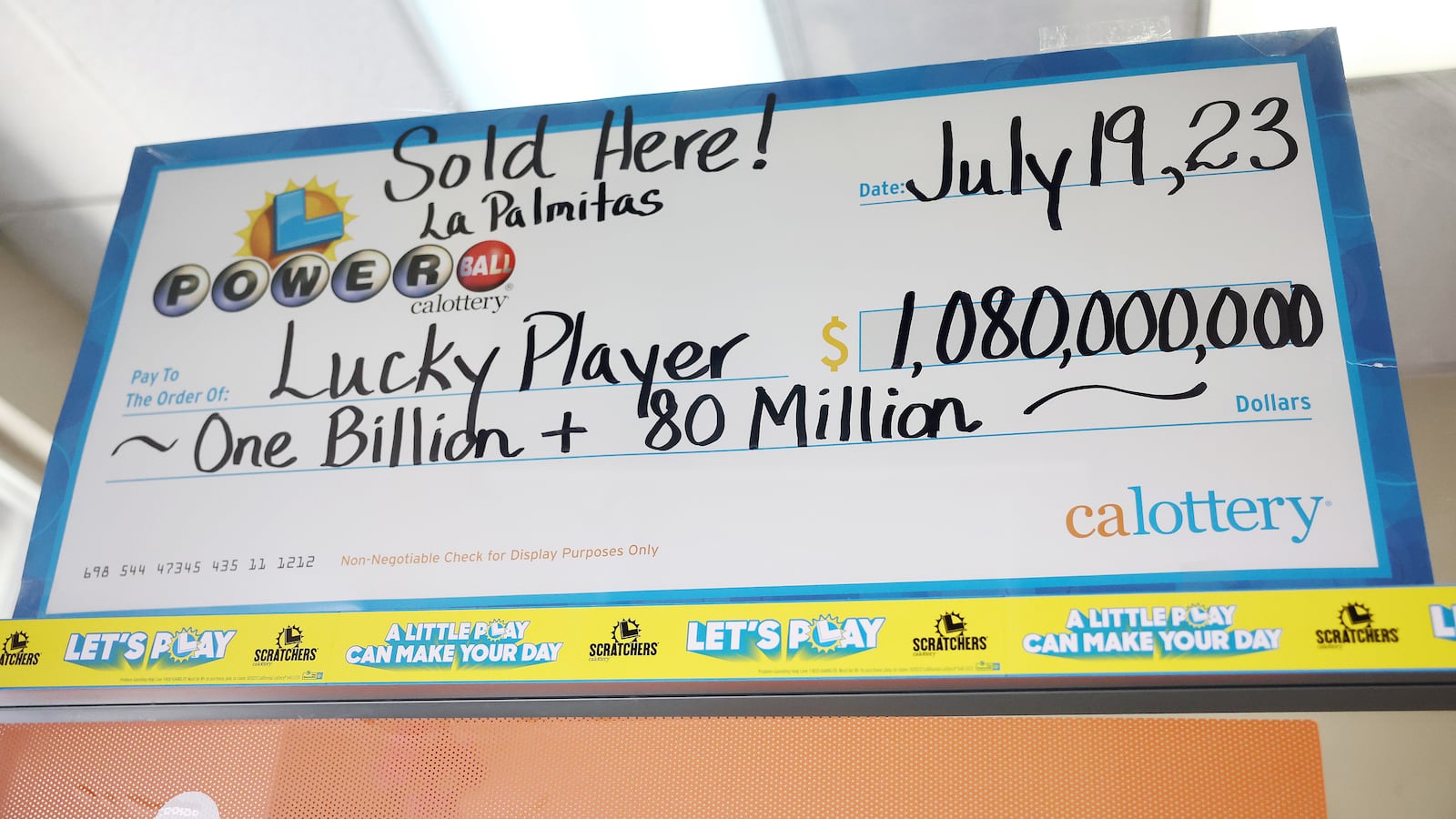 An enlarged symbolic check for $1.08 billion hangs in Las Palmitas Mini Market in Los Angeles, California