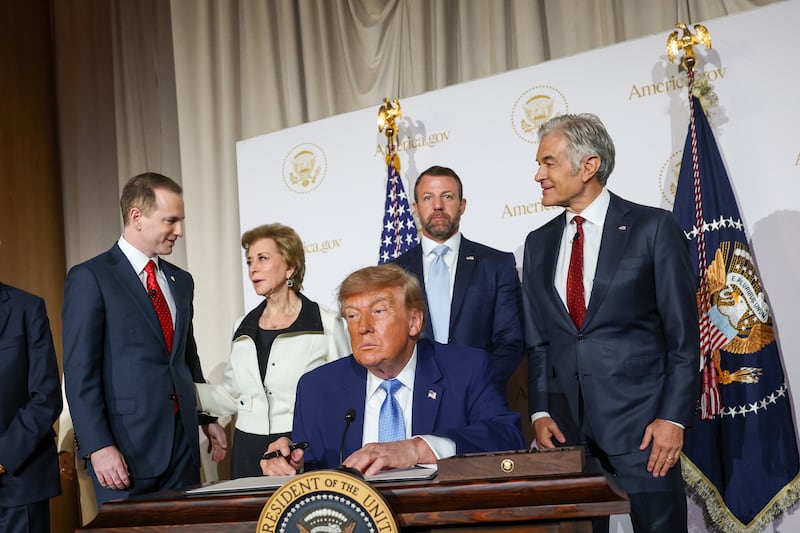 WASHINGTON, DC - SEPTEMBER 29: U.S. President Donald Trump signs an executive order during the America.gov launch event at Andrew W. Mellon Auditorium on September 29, 2026 in Washington, DC. The website features an artificial intelligence tool to help Americans interact with the federal government. The event was attended by tech leaders Elon Musk, Nvidia CEO Jensen Huang and Blue Origin CEO Dave Limp, along with U.S. Vice President JD Vance and U.S. Secretary of State Marco Rubio. (Photo by Kevin Dietsch/Getty Images)