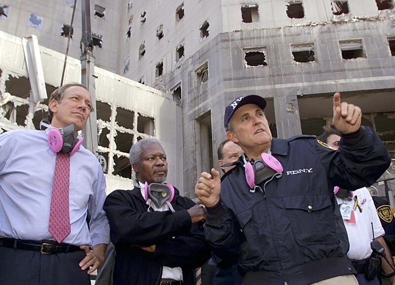 New York Mayor Rudy Giuliani (R) gives a tour of the World Trade
Center attack site to United Nations Secretary General Kofi Annan (C)
and New York state Governor George Pataki (L), September 18, 2001.