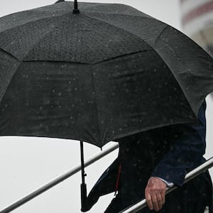 President Donald Trump steps off Air Force One under an umbrella upon arrival at Atlantic Aviation at Cleveland Hopkins International Airport in Cleveland, Ohio, on August 11, 2026. Trump is attending the Patriot Games at SPIRE Academy in Geneva, Ohio.