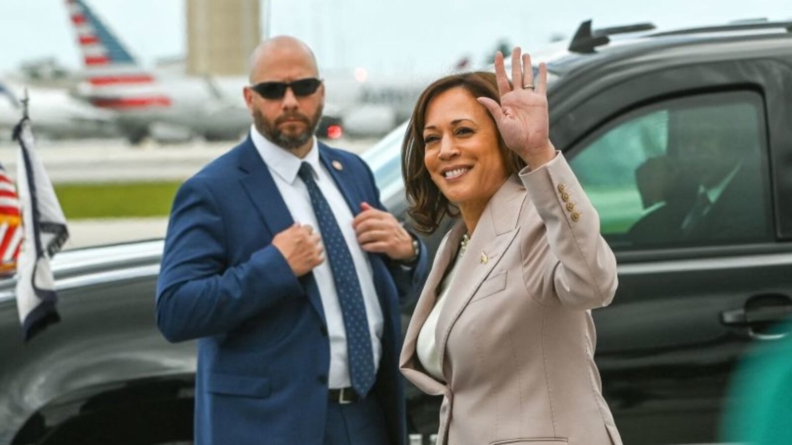 US Vice President Kamala Harris waves while walking to her vehicle