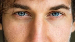 Close up of man's blue eyes looking at camera