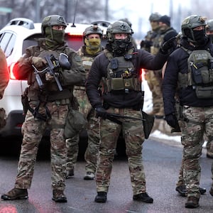 US Border Patrol agents holding less-lethal weapons stand guard at the Bishop Henry Whipple Federal Building in Minneapolis, Minnesota, on January 8, 2026. A US Immigration and Customs Enforcement (ICE) agent shot and killed an American woman on the streets of Minneapolis January 7, leading to huge protests and outrage from local leaders who rejected White House claims she was a domestic terrorist. The woman, identified in local media as 37-year-old Renee Nicole Good, was hit at point blank range as she apparently tried to drive away from agents who were crowding around her car, which they said was blocking their way.