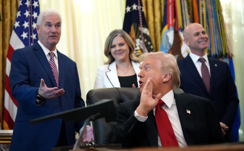 U.S. President Donald Trump (R) turns to talk to House Majority Whip Tom Emmer (R-MN) as he delivers remarks on lowering drug prices in the Oval Office at the White House on November 06, 2025 in Washington, DC.