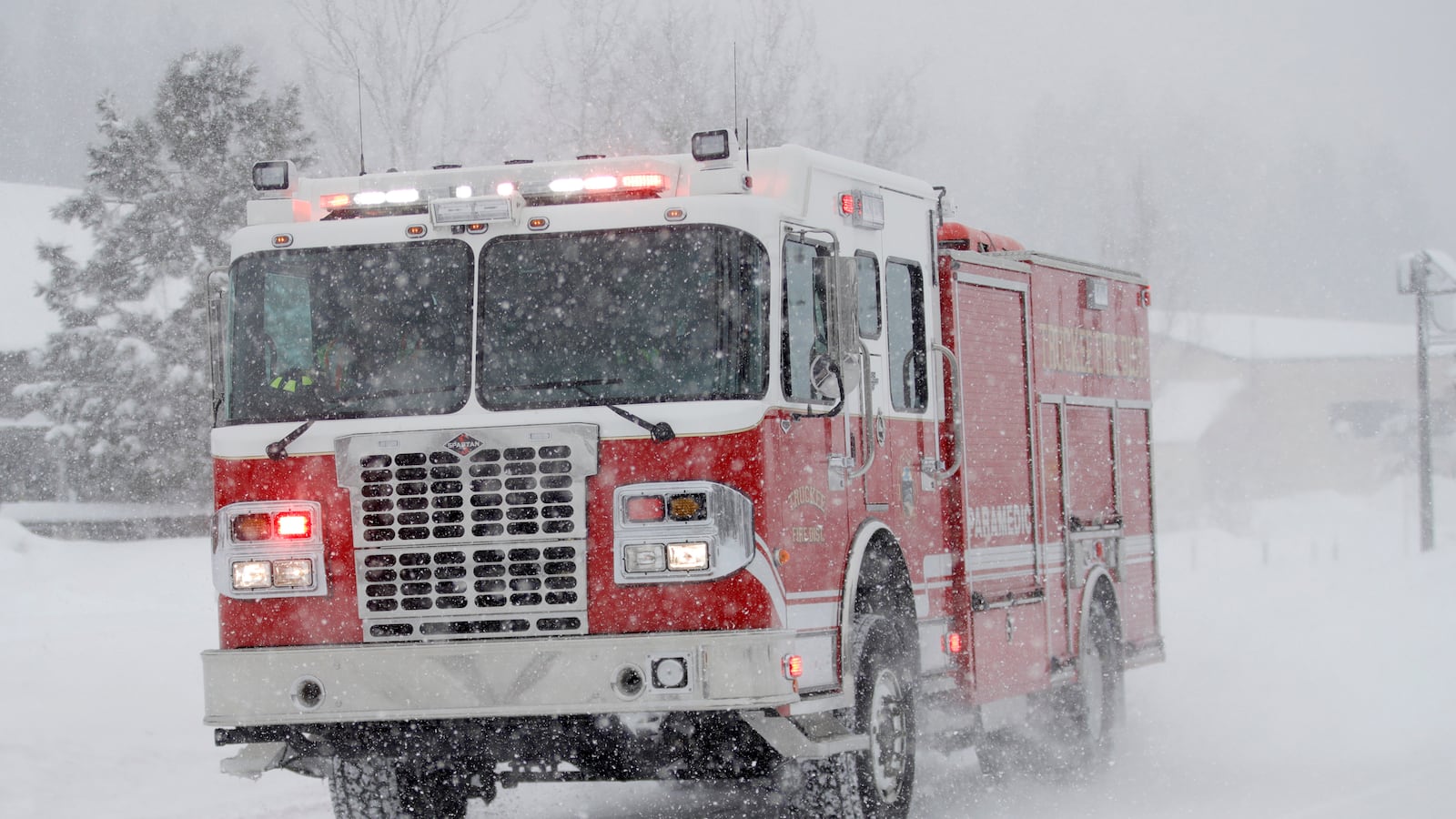 Firefighters respond to a call as snow continues to fall in Truckee, Calif., on Saturday, March 2, 2024.